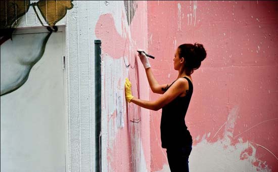 Portrait of Lisa King creating a street artwork